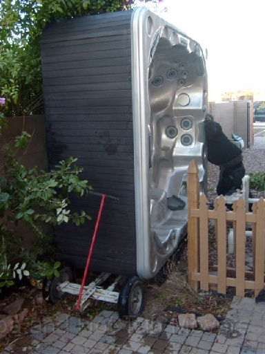 Az Spa and Hot Tub Movers removing a spa through a narrow gate way